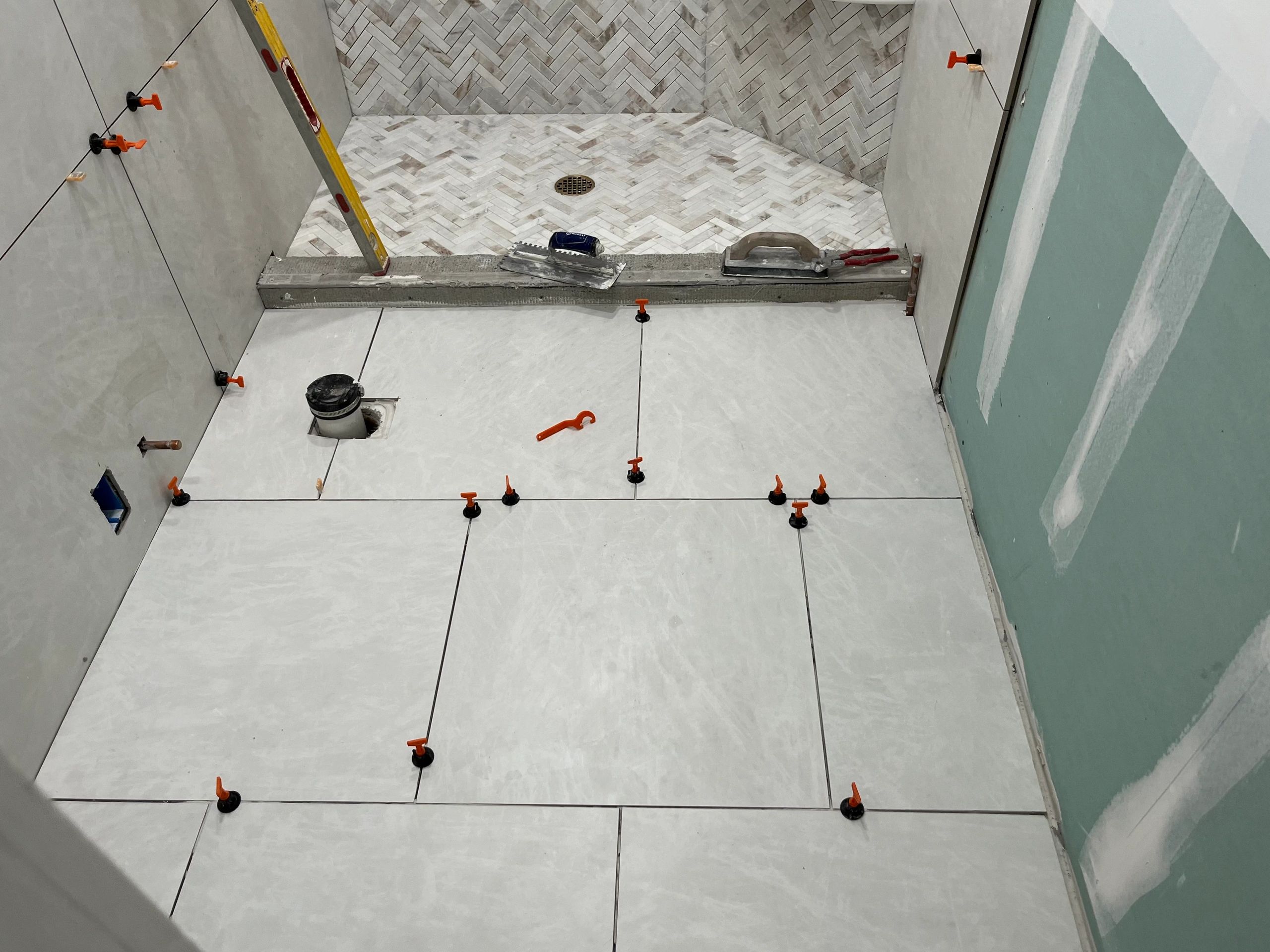 Shower tile installation herringbone pattern